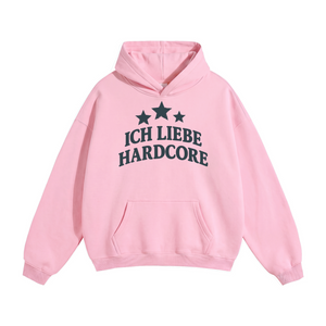 A light pink unisex oversize pullover hoodie with a front kangaroo pocket and a dark navy graphic on the chest featuring three stars and the German text 'ICH LIEBE HARDCORE'.